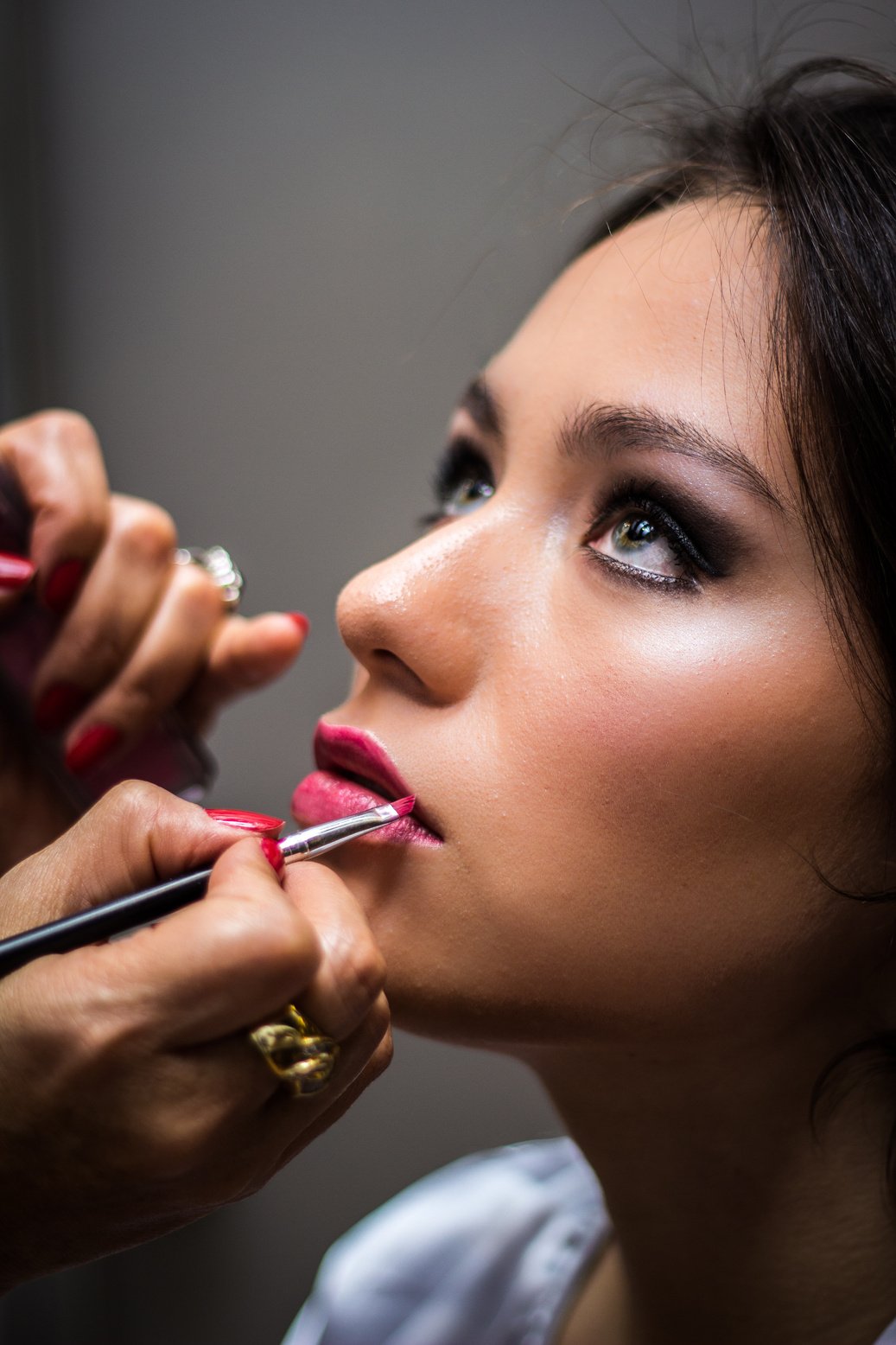 Woman Putting Lipstick on Her Lips